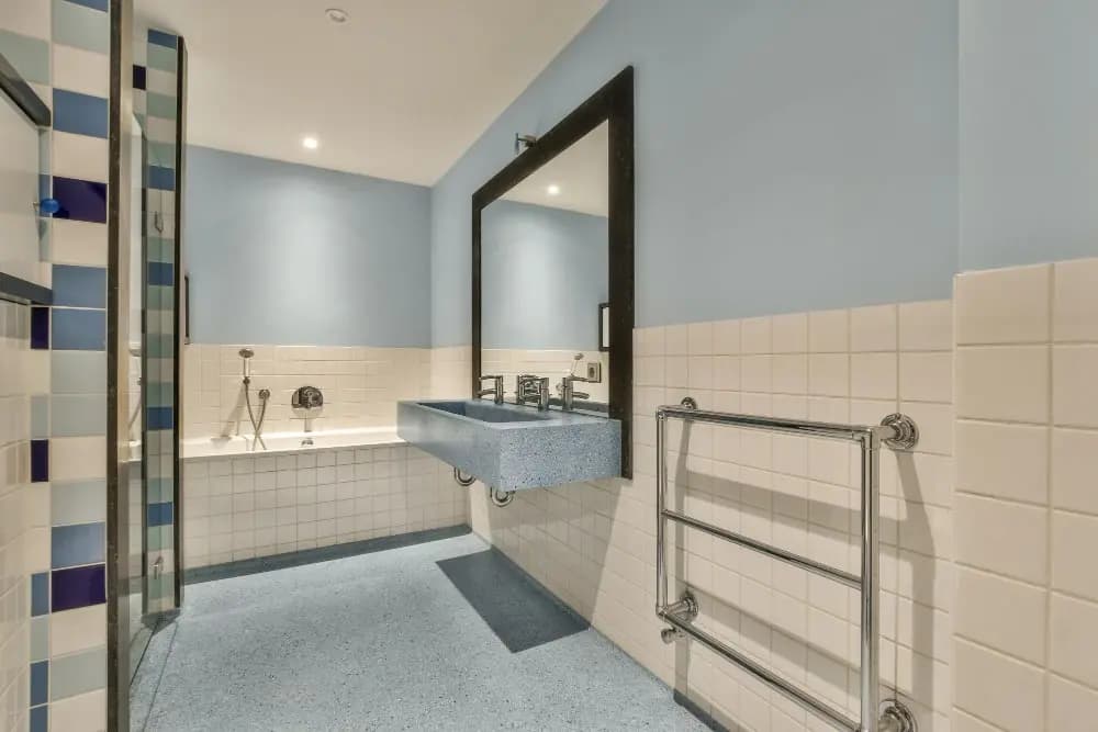 Completed bathroom with a bath, basin and accessible plumbing fixtures
