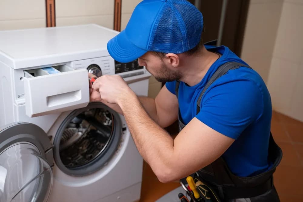 Technician checking the detergent drawer on a front-loading washing machine